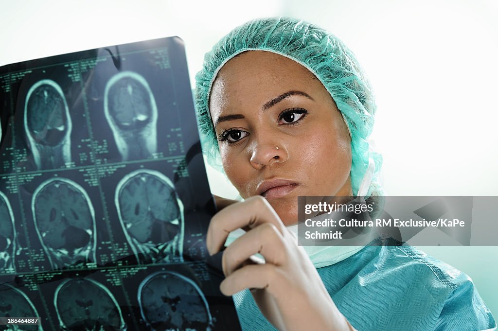 Surgeon inspecting scan