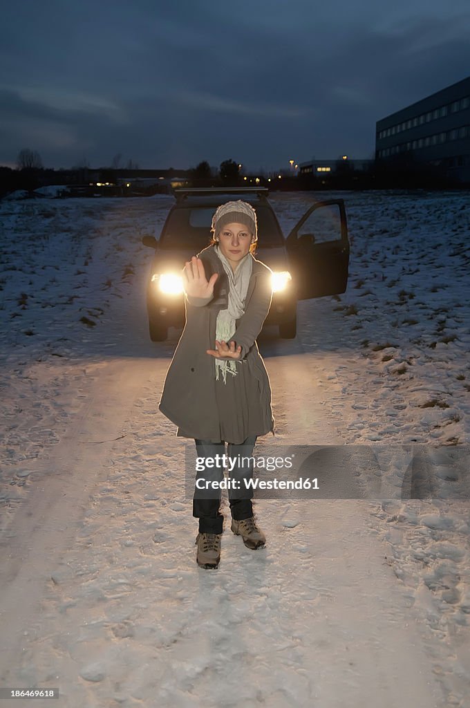 Germany, Brandenburg, Young woman with car breaks down at night