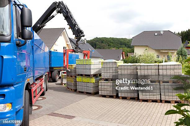 germany, rhineland palatinate, truck unloads stacks of paving stone - dump truck stock-fotos und bilder