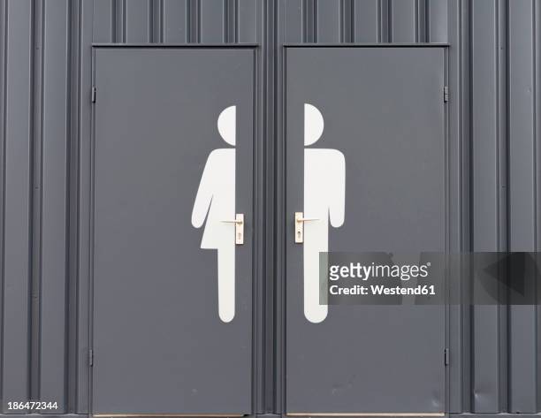germany, male and female sign on toilet door - gender fotografías e imágenes de stock