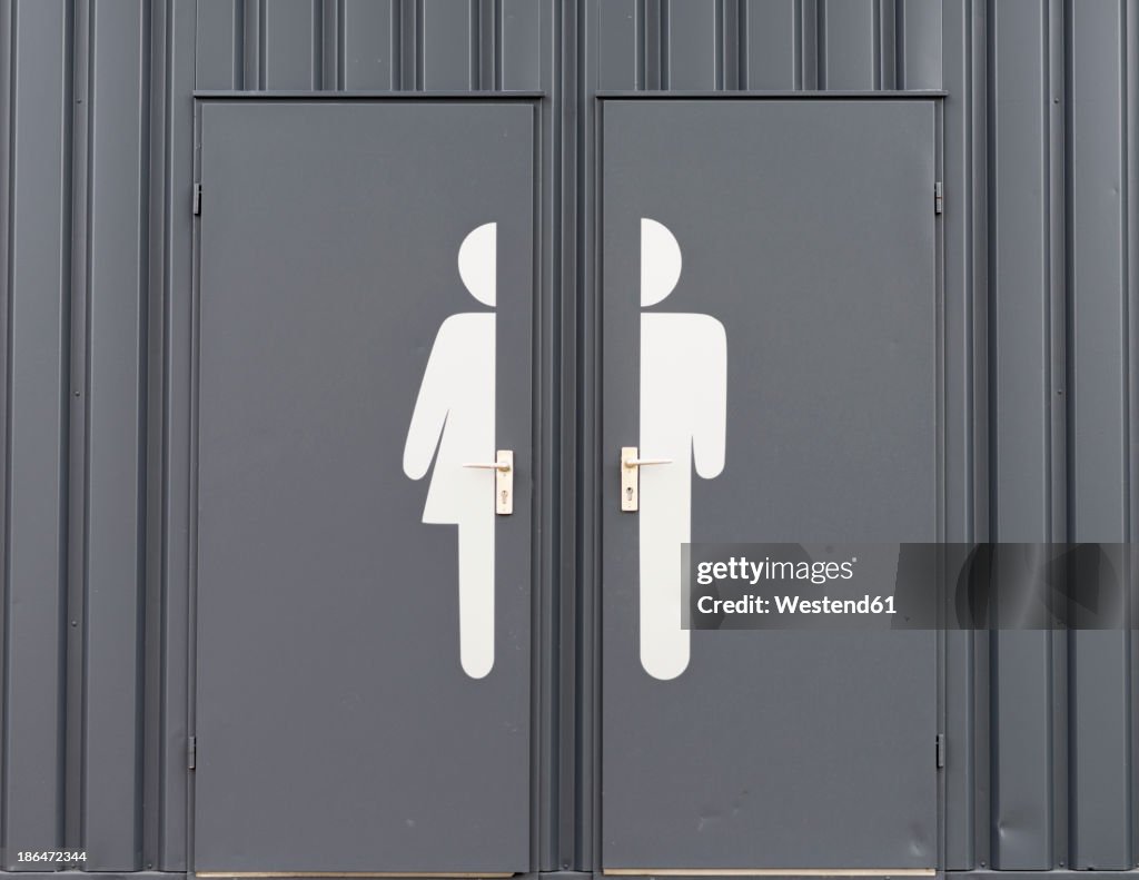 Germany, Male and female sign on toilet door