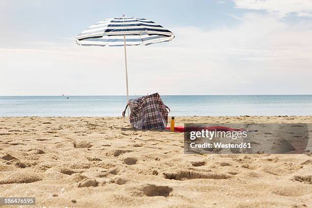 spain, beach umbrella and towel at palma de mallorca - strandväska bildbanksfoton och bilder