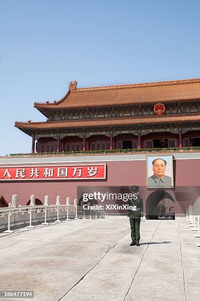 tiananmen square, gate of heavenly peace with mao's portrait and guard, beijing, china. - tiananmen square stock pictures, royalty-free photos & images