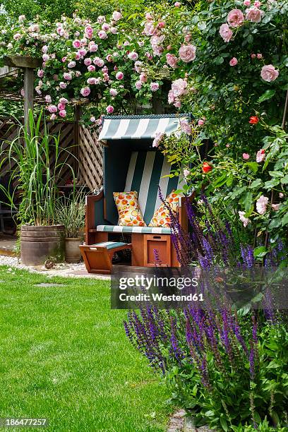 germany, north rhine westphalia, drensteinfurt, beach chair in rose garden - hooded beach chair stock pictures, royalty-free photos & images