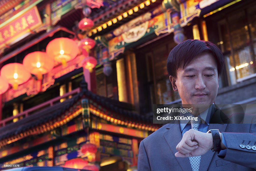 Businessmen checking his watch.