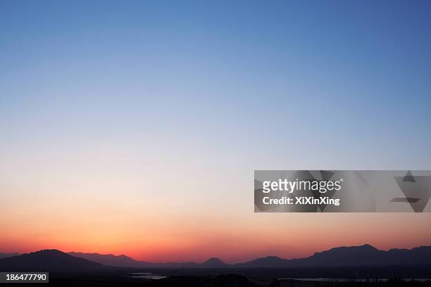 landscape of mountain range and the sky at dusk, china - dusk foto e immagini stock