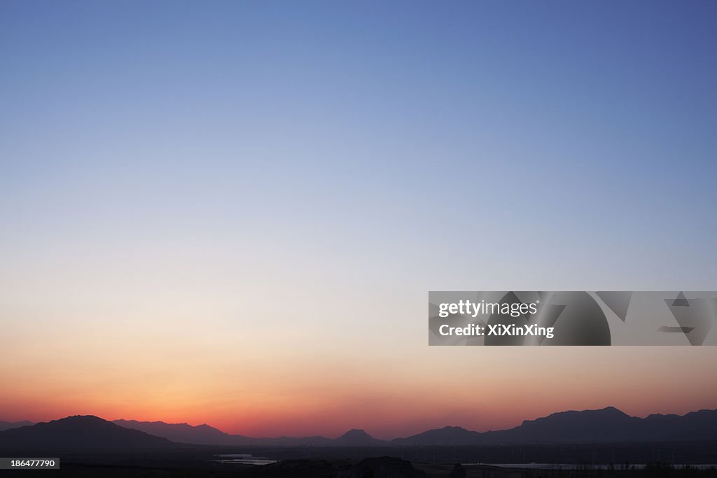 Landscape of mountain range and the sky at dusk, China