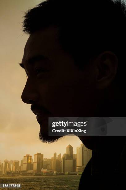 silhouette and profile of young man, close-up on face, studio shot - man silhouette profile stock pictures, royalty-free photos & images