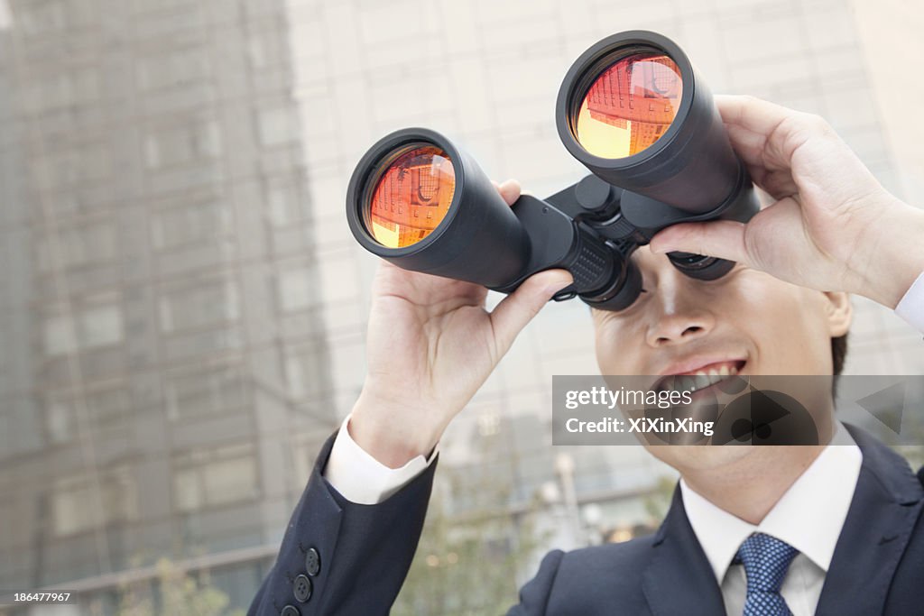 Smiling Businessman Using Binoculars, Reflection