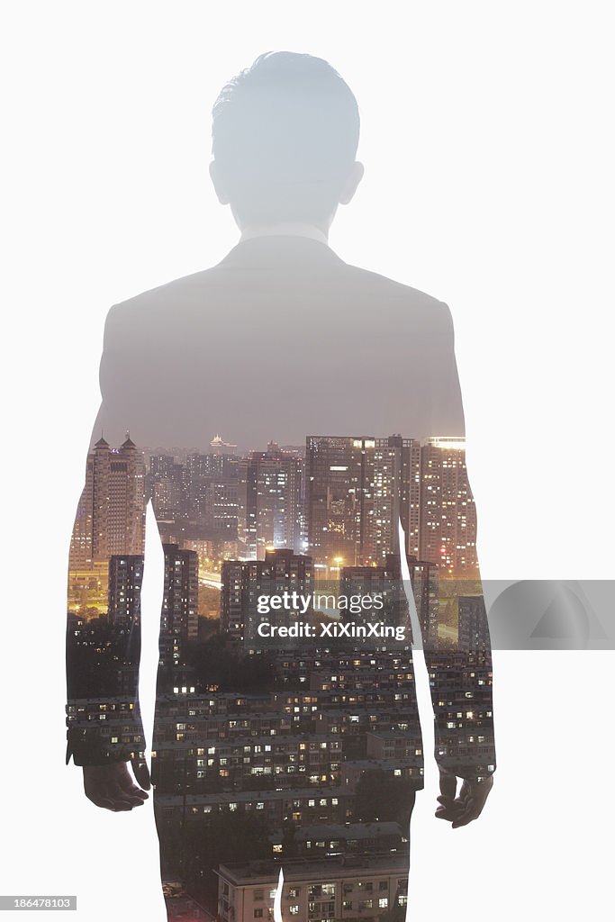 Double exposure of young businessman and the skyline of Shanghai, China