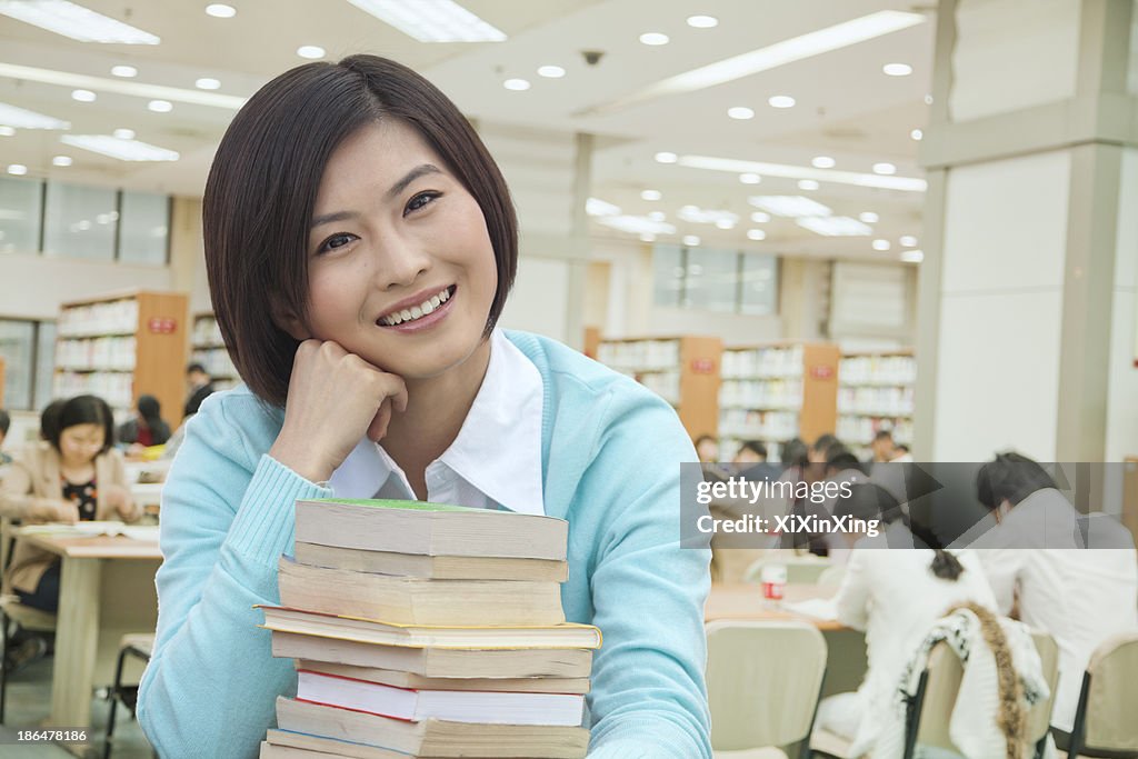 Portrait of Smiling Young Woman in Library