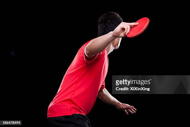man playing ping pong, black background - tischtennis spielerin stock-fotos und bilder