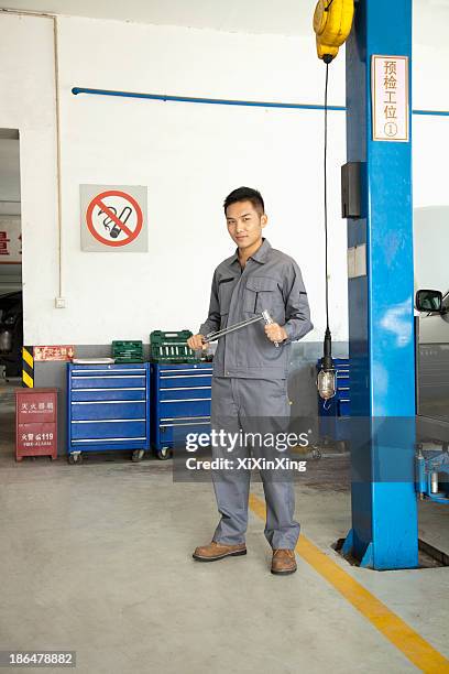 portrait of garage mechanic - adjustable wrench stock-fotos und bilder