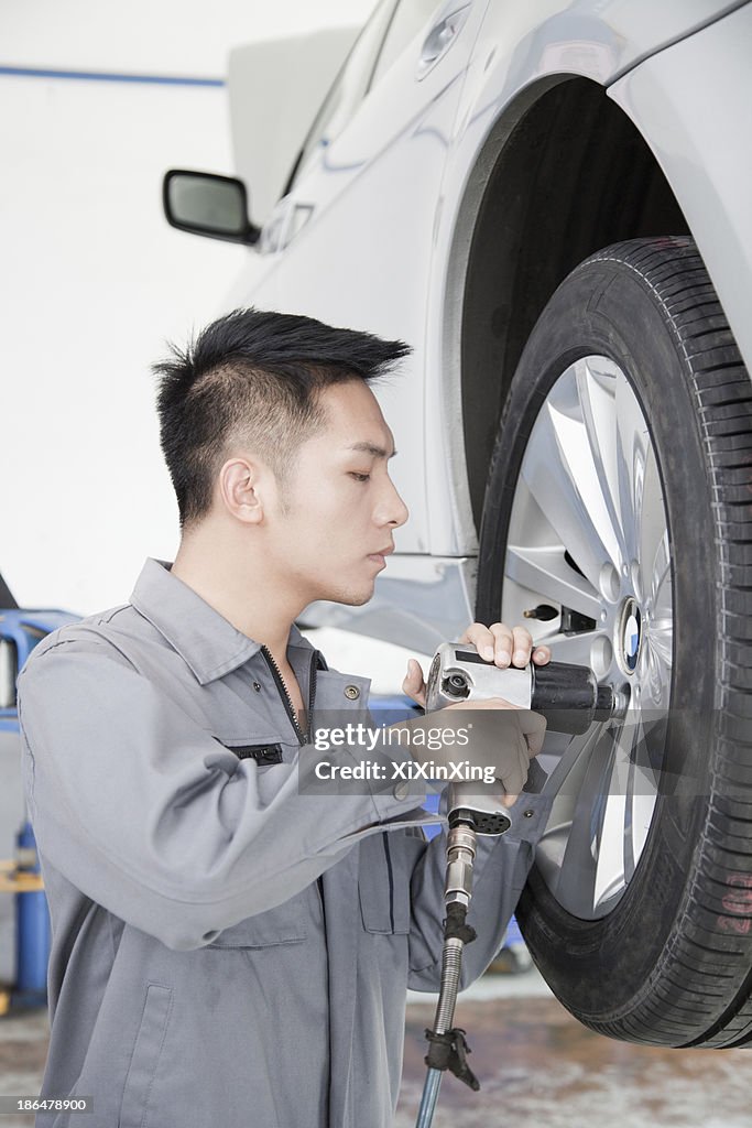 Mechanic Using Power Tool