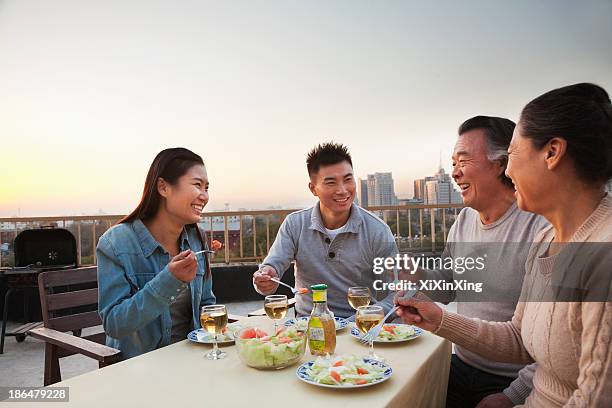 family barbeque party - asian couple dinner stockfoto's en -beelden