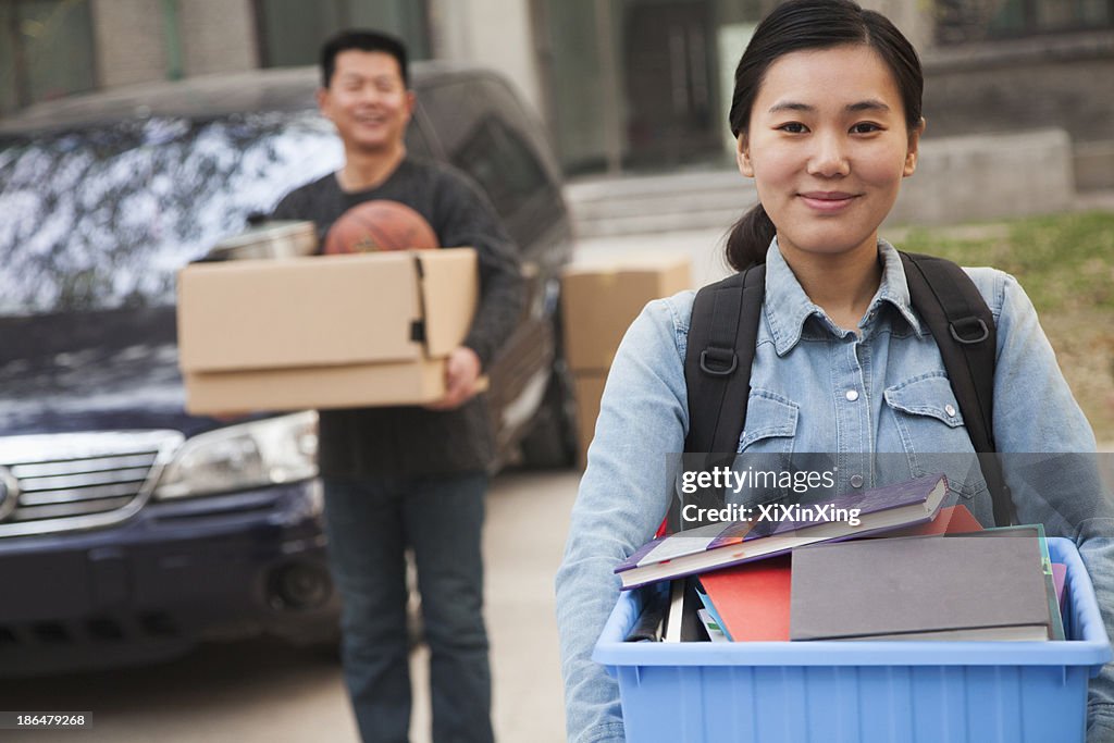 Student portrait in front of dormitory at college