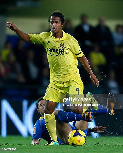 Getafe's midfielder Jaime Gavilan vies with Villarreal's Mexican forward Giovani Dos Santos during the Spanish league football match Villarreal CF vs...