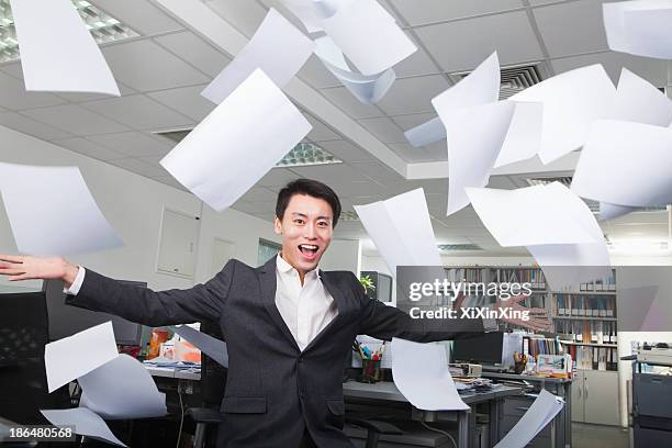 white-collar worker throwing white sheets in air in office - super excited suit stock pictures, royalty-free photos & images