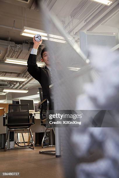 businessman preparing to throw paper into wastebasket - flip flop stockfoto's en -beelden