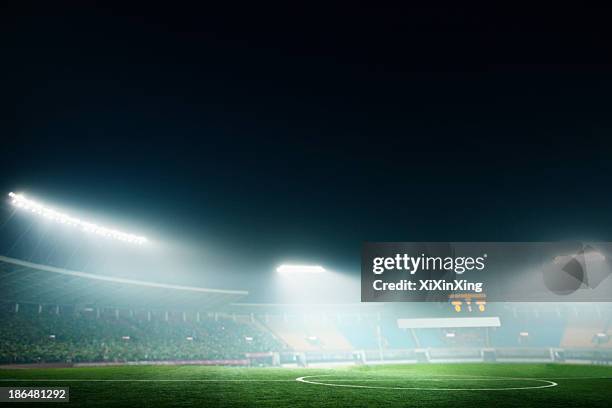 digital coposit of soccer field and night sky - football stadium night stock pictures, royalty-free photos & images