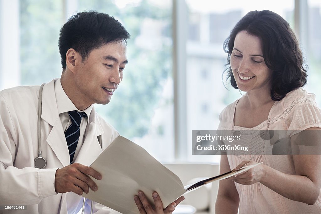 Doctor and patient sitting down and discussing medical record in the hospital