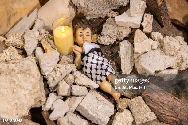 The Nativity scene shows baby Jesus wrapped in a keffiyeh and placed in a pile of rubble to show solidarity with the people of Gaza on December 18,...