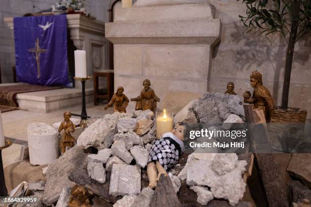 The Nativity scene shows baby Jesus wrapped in a keffiyeh and placed on a pile of rubble on December 18, 2023 in the Evangelical Lutheran Christmas...