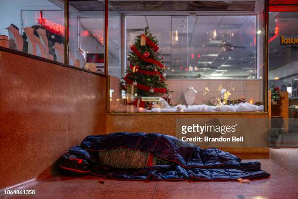 An unhoused resident sleeps outside a dimly lit store on December 18, 2023 in Austin, Texas. The federal government has reported an increase in...