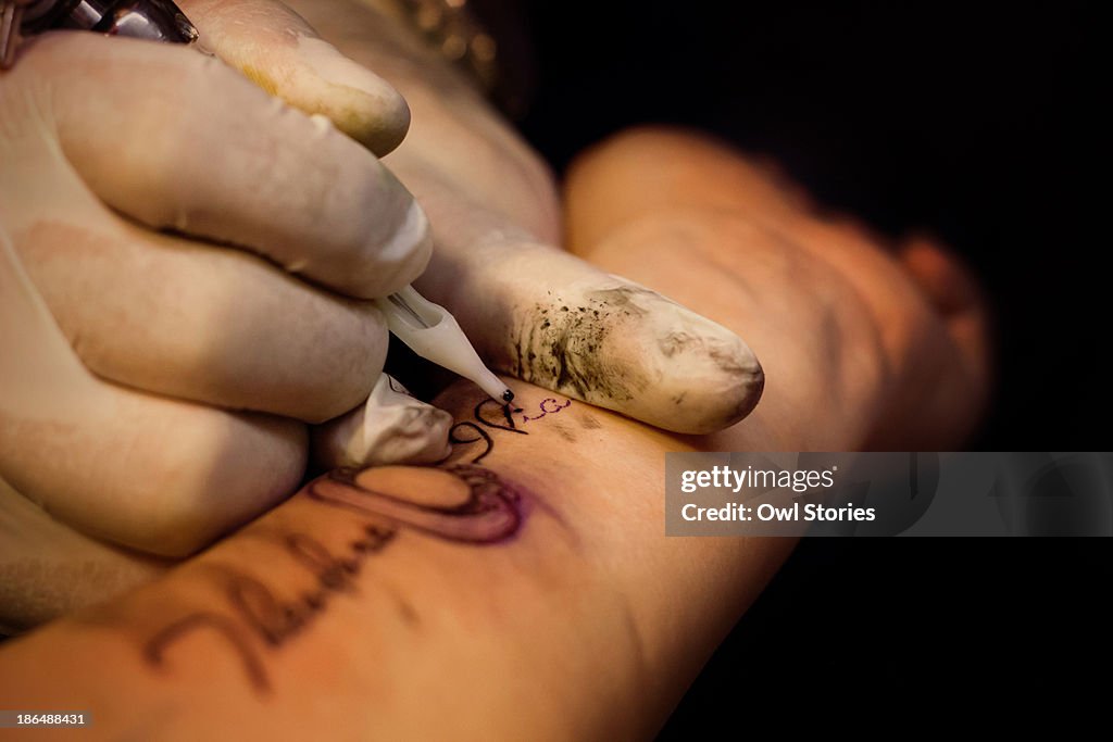 Tattoo artist working on a tattoo