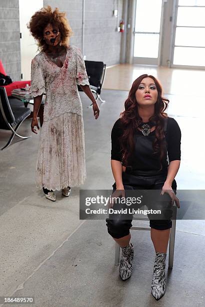 Singer Guinevere sings at her live performance while a "zombie" approaches at VEVO headquarters on October 31, 2013 in Los Angeles, California.