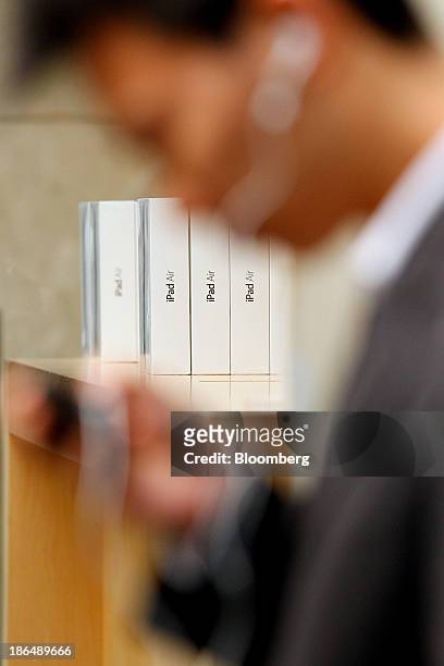 Man uses an Apple Inc. IPhone while waiting in line to purchase a new iPad Air at the George Street store in Sydney, Australia, on Friday, Nov. 1,...