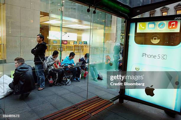 Customers wait in line to purchase outside Apple's Inc.'s the George Street store ahead of the launch of the companys iPad Air in Sydney, Australia,...