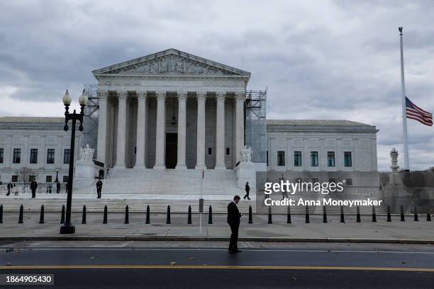Flags fly at half-staff on the front plaza of the U.S. Supreme Court Building before the funeral service for retired Supreme Court Justice Sandra Day...