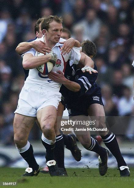 Nathan Hines of Scotland tries to tackle Matt Dawson of England during the Royal Bank of Scotland Six Nations Championship match between England and...