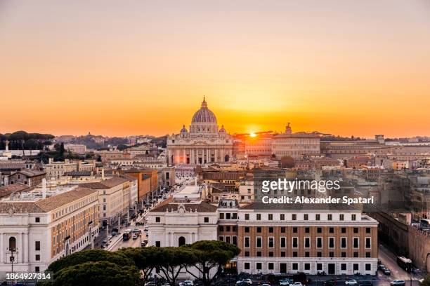 aerial panoramic view of rome skyline with st. peter's basilica at sunset, italy - vatican city aerial stock pictures, royalty-free photos & images