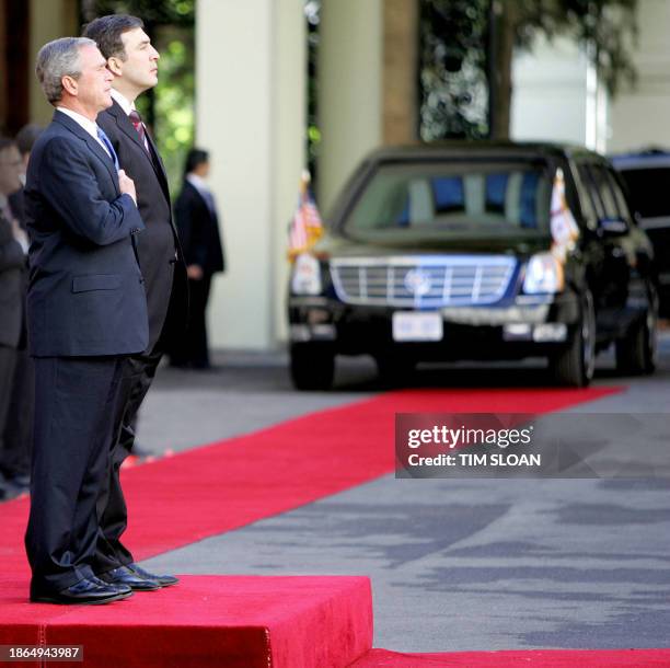 President George W. Bush and his Georgian counterpart Mikhail Saakashvili listen to national anthems 10 May 2005 at the parliament in Tbilisi. AFP...