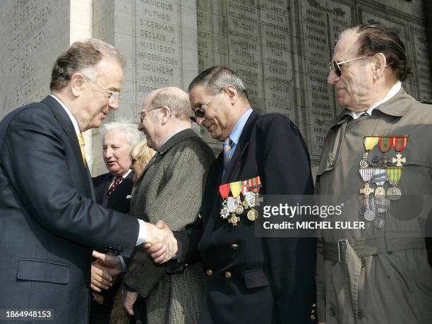 Portugal's President Jorge Sampaio shakes hands with unidentified war veterans after laying a wreath at the Tomb of the Unknown Soldier at the Arc de...