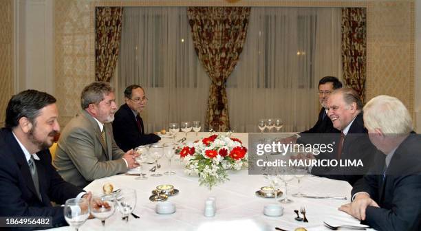 The elected president of Brazil, Luis Inacio Lula da Silva and his advisors, speak with Enrique Iglesias, president of the Interamerican Development...