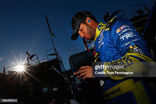 Darrell Wallace Jr., driver of the Camping World / Good Sam Toyota, looks on in the garage area during practice for the NASCAR Camping World Truck...