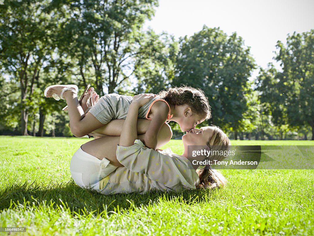 Mother and daughter playing in the park