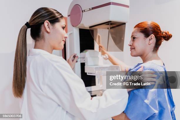 doctor doing mammogram exam on patient at hospital - bröstcancer bildbanksfoton och bilder