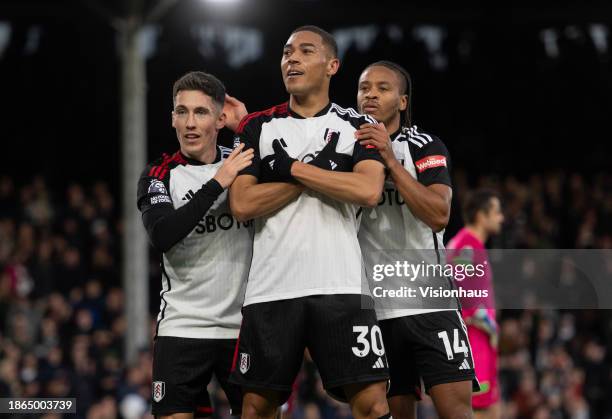 Carlos Vinicus of Fulham celebrates scoring his teams fifth goal with Bobby Decordova-Reid and Harry Wilson of Fulham during the Premier League match...