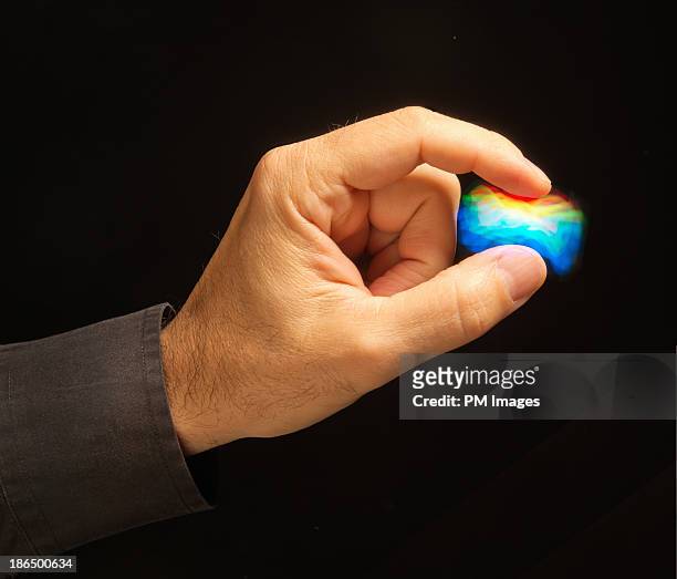 pinching multi colored energy - pinching stock pictures, royalty-free photos & images