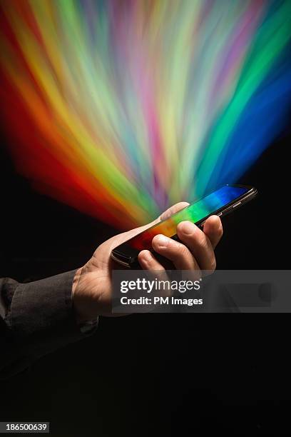 rainbow of colors from smartphone - paranormal stock pictures, royalty-free photos & images