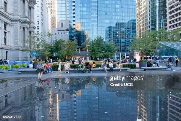 People gather by the reflecting pools in front of the City Hall, Philadelphia, Pennsylvania.