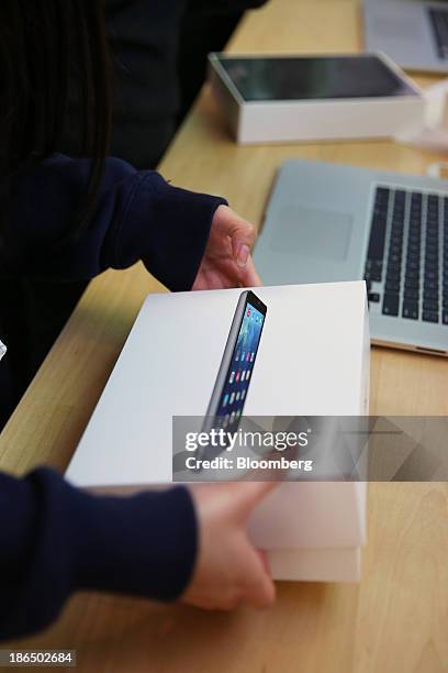 Customer opens a box containing a new Apple Inc. IPad Air at the company's George Street store in Sydney, Australia, on Friday, Nov. 1, 2013. Apple...