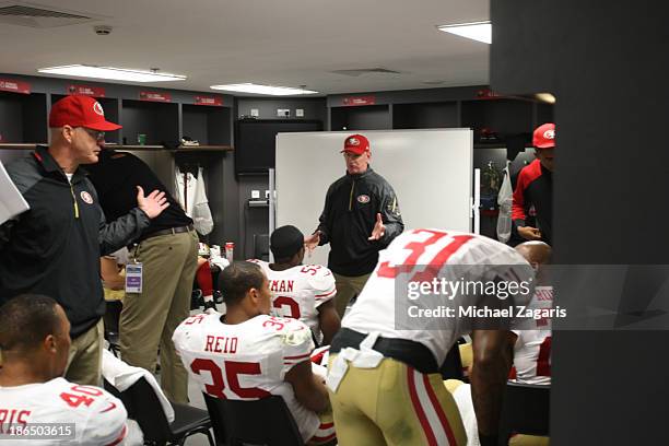 Linebackers Coach Jim Leavitt and Secondary Coach Ed Donatell of the San Francisco 49ers talks wit the team in the locker room during halftime of the...