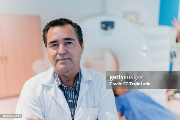 portrait of a doctor on tomography room at hospital - neurologist stock pictures, royalty-free photos & images