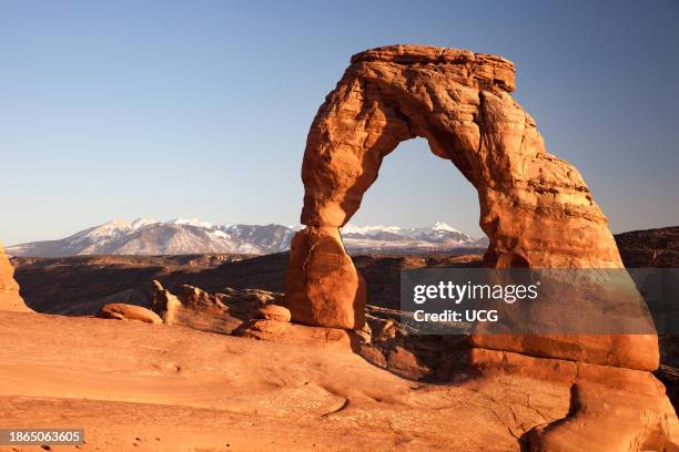 Delicate Arch and Jurassic sandstone of the Entrada Formation, Arches National Park, Utah. La Sal Mountains form the background.