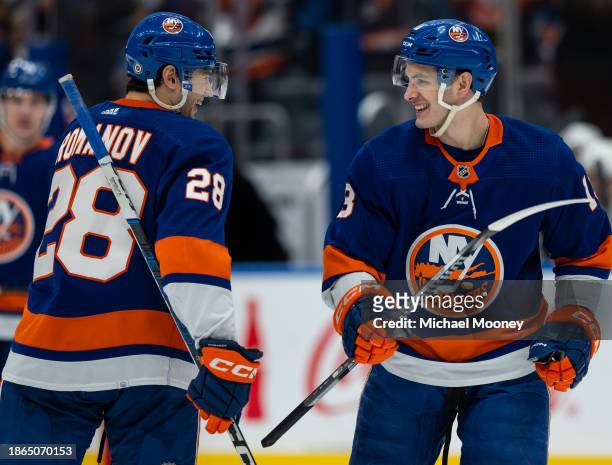 Alexander Romanov of the New York Islanders celebrates his second period goal with Mathew Barzal during a game against the Boston Bruins at UBS Arena...
